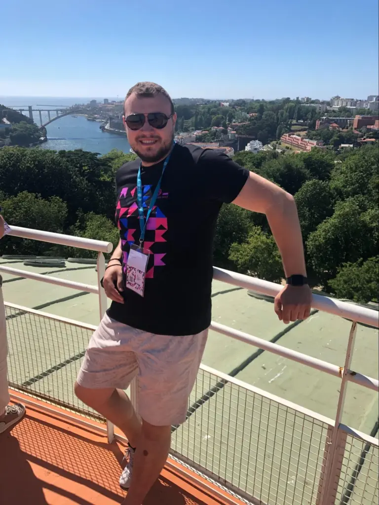 Volodymyr leaning on a handrail with Krakow in the background.